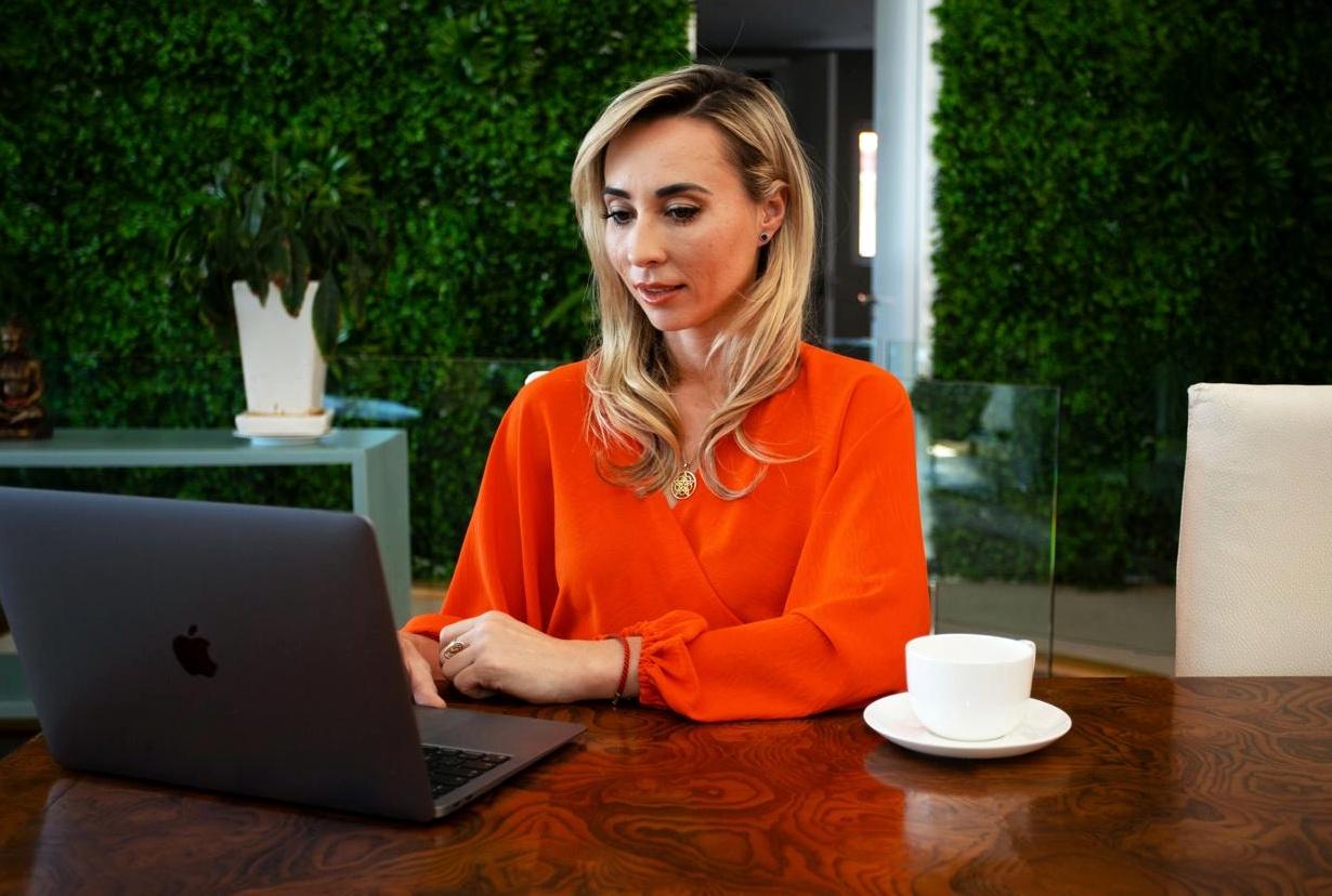 Svitlana Iustin working at her desk
